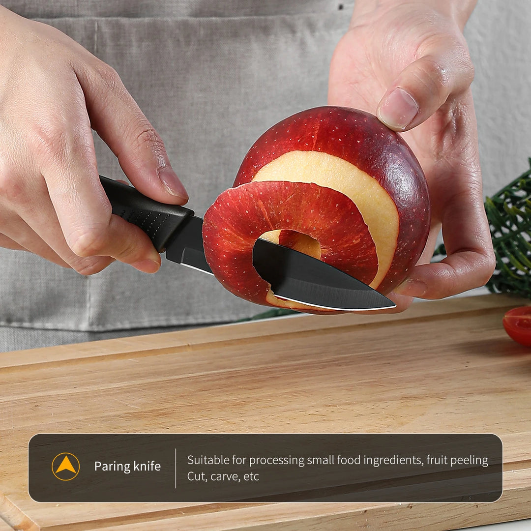 Person using a paring knife to cut an apple on a wooden cutting board.