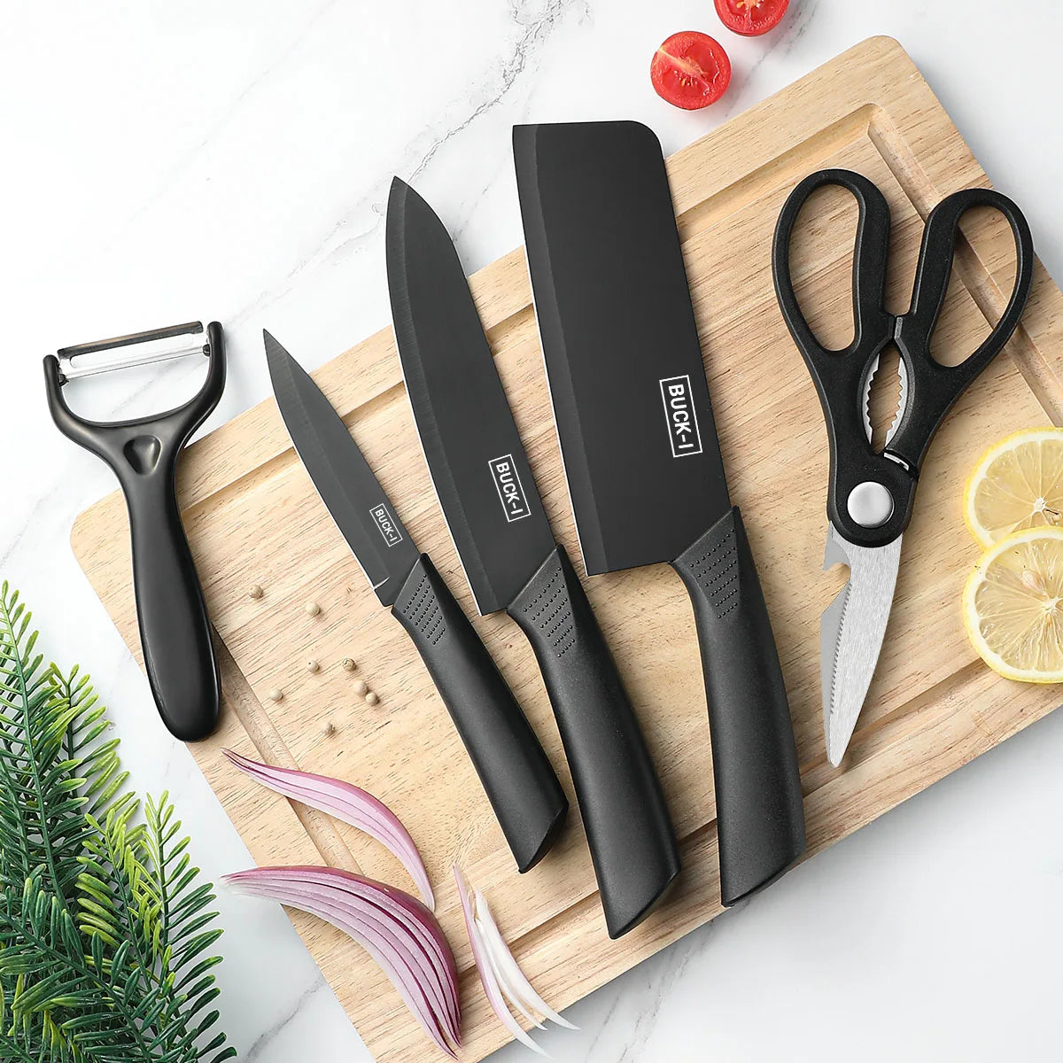 Set of black kitchen knives and tools on a wooden cutting board with vegetables.