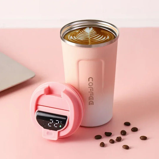 Pink coffee tumbler with digital temperature display on a pink background