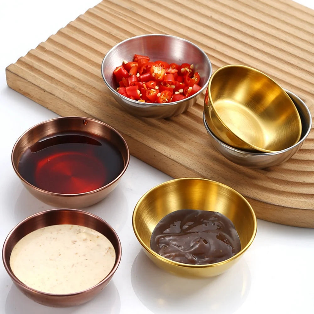 Set of small metal bowls with various contents on a wooden board
