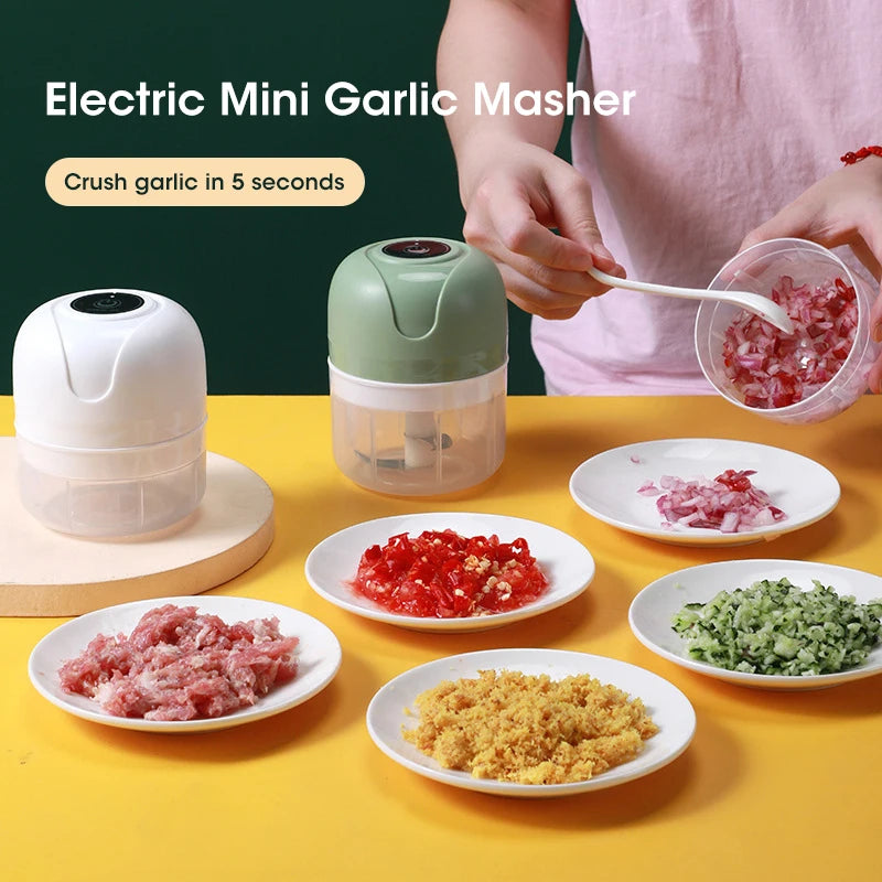 Electric mini garlic masher with garlic products on a yellow background
