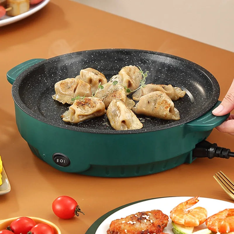 Green electric hot pot with dumplings on a wooden table