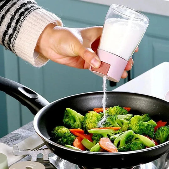 Person seasoning vegetables in a pan with a salt grinder