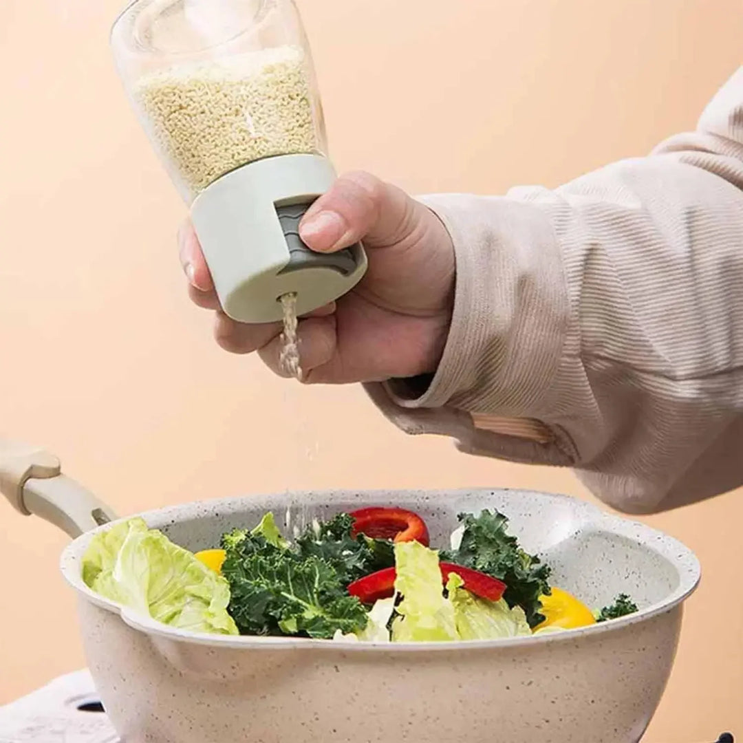 Person using a salad spinner to dry greens with a beige background