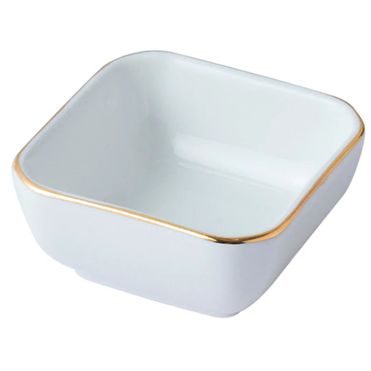 White square bowl with gold rim on a white background