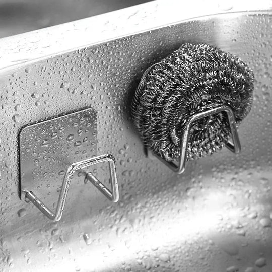 Metal scrubber on a wet surface with water droplets
